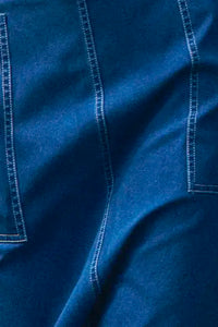 Denim midi skirt framed by patch pockets with crisp topstitching and a removable belt with a D-ring.