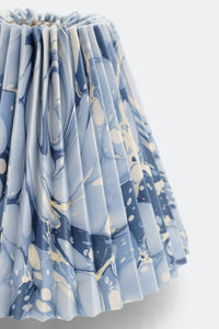 Close-up of hand-marbled pleated lampshade with ocean wave pattern on blue-gray fabric - Inner Child