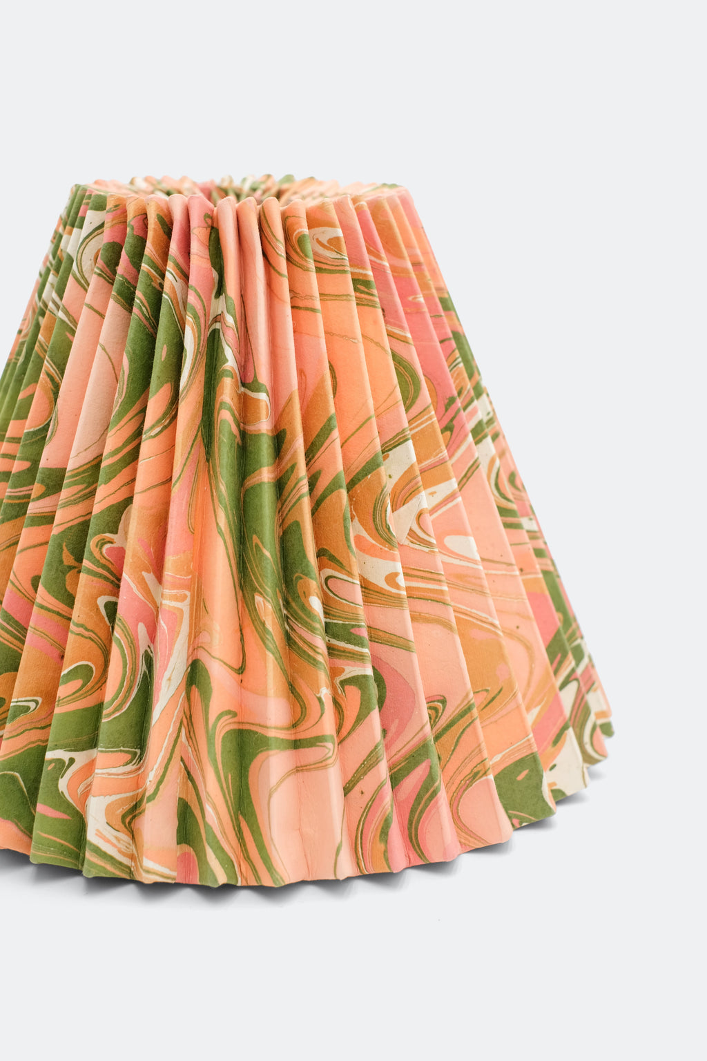 10-inch hand-marbled pleated empire lampshade in Peony Bloom pattern, showcasing soft peach, green, and white marbled fabric with vertical pleats.