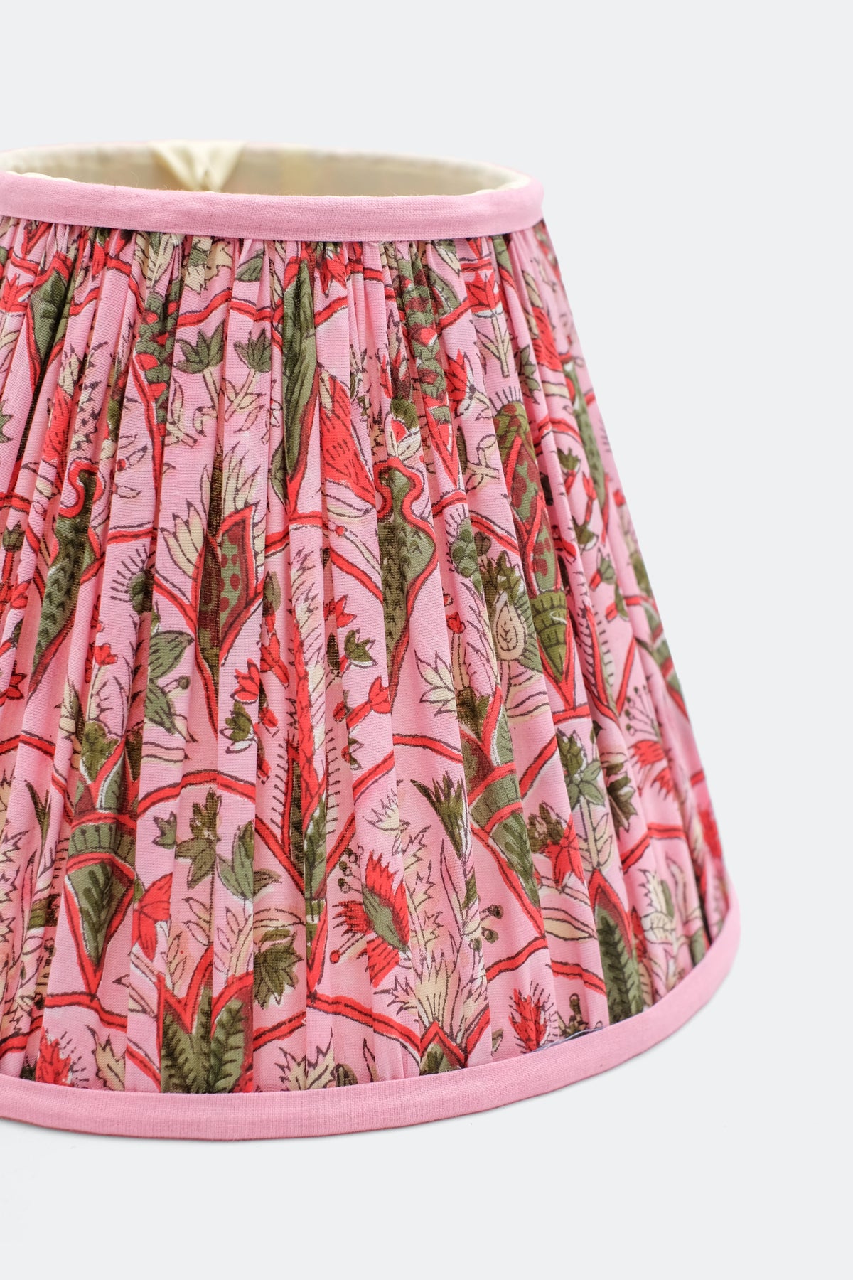 10-inch pleated empire lampshade in pink with Pink Arch blockprint pattern featuring red, green, and white floral motifs