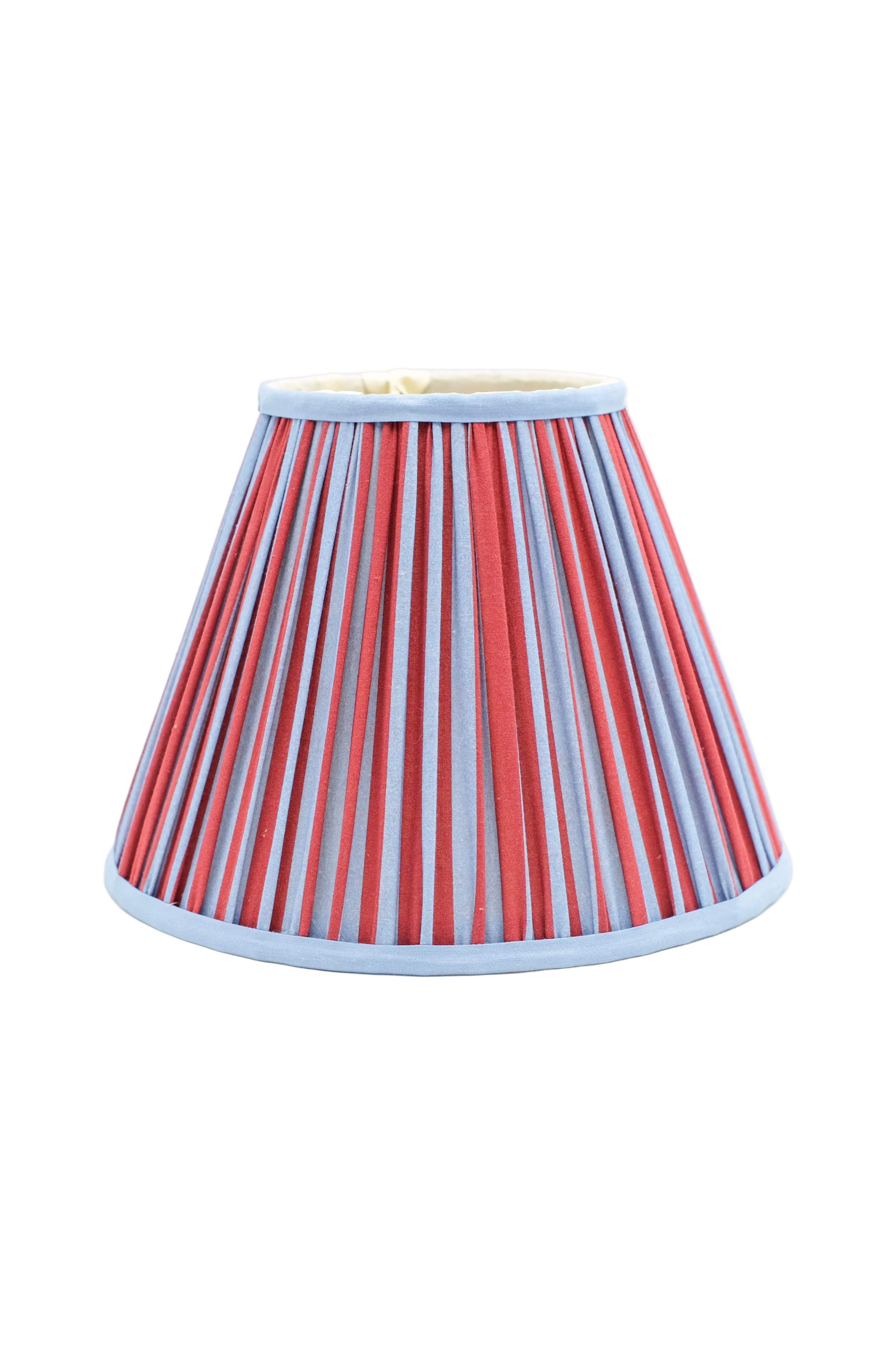 10-inch pleated empire lampshade with Red and Blue Stripes pattern, light blue trim, front view