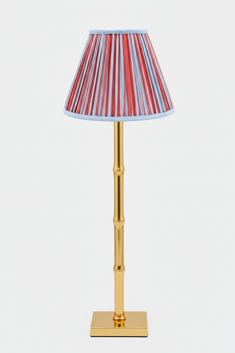 10-inch pleated empire lampshade with Red and Blue Stripes pattern on a gold bamboo-style table lamp base