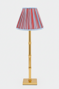 10-inch pleated empire lampshade with Red and Blue Stripes pattern on a gold bamboo-style table lamp base