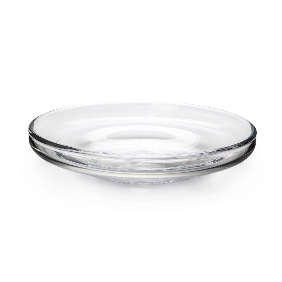 Angled front view of Walden Platter showcasing broad flat surface and low rounded rim in clear mouthblown glass on white background