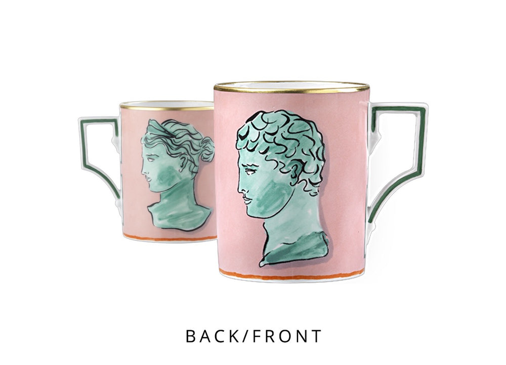 Front and back view of Il Viaggio Di Nettuno pink mug with green classical busts, gold rim, and square handle on white