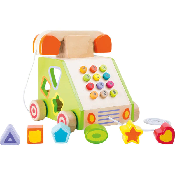 Front view of the wooden Telephone Shape Sorter showcasing its number pad, shape blocks, pull cord, and wheels