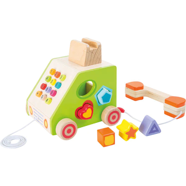 Angled view of wooden Telephone Shape Sorter with shape holes, number pad, pull cord, and receiver on white