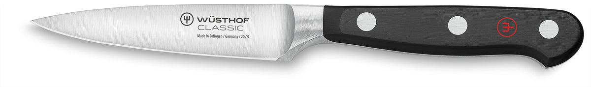 Side view of Wüsthof 3.5-inch Classic paring knife showing stainless-steel blade and triple-riveted black handle on white