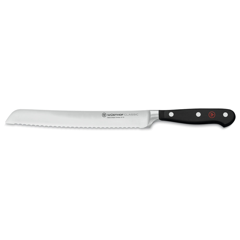 Side view of Wüsthof 8-inch Classic bread knife with serrated blade and full-tang triple-riveted black handle on white