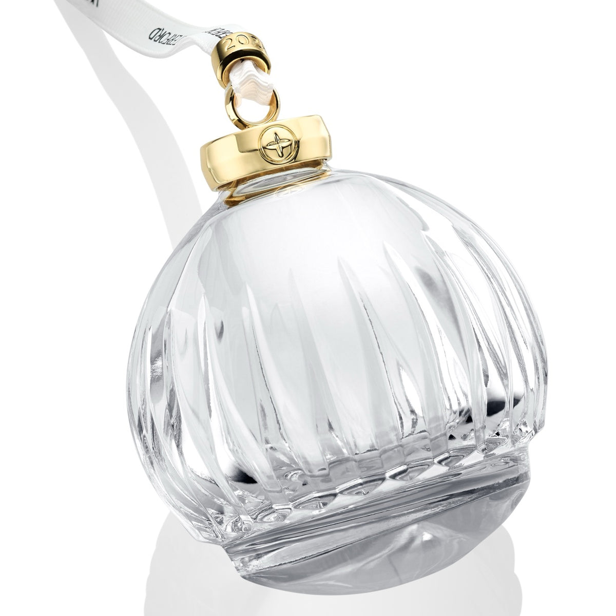 Angled close-up of Waterford New Year Firework crystal bauble showcasing bold linear cuts, gold cuff, and white branded ribbon on white background