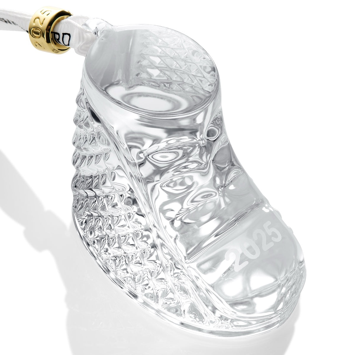 Angled view of Baby’s First Boot Ornament showcasing crystal diamond cuts and 2025 marking with a Waterford ribbon on a white background