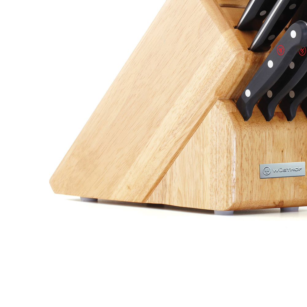 Close-up of Gourmet 12-piece knife block showing natural wood finish, black-handled knives, and Wüsthof metal brand plaque on white background