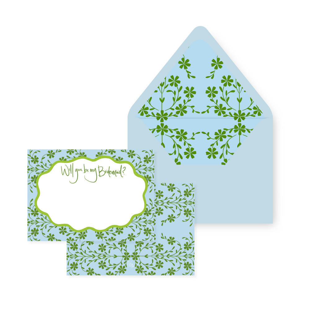 Angled view of Cornflower Botanical Gardens stationery: 5x7 floral card reading Will you be my Bridesmaid and matching floral-lined envelope