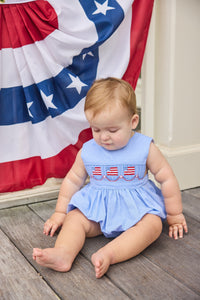 Little English traditional children's clothing.  Sleeveless bubble in royal blue mini check fabric and smocking at the chest with American flag bunting for baby boys