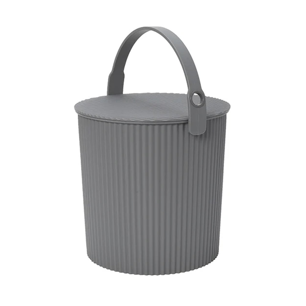 Three-quarter view of Hachiman Bucket Large in New Grey showcasing ribbed exterior, lidded top, and upright carry handle on white background