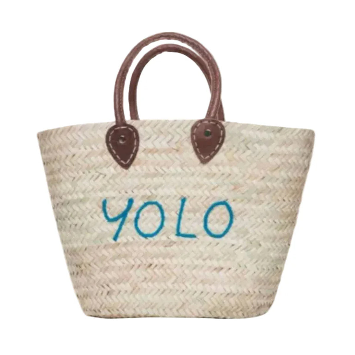 Front view of Medium Beach Tote showcasing blue embroidered YOLO on straw body with brown leather top handles on white background