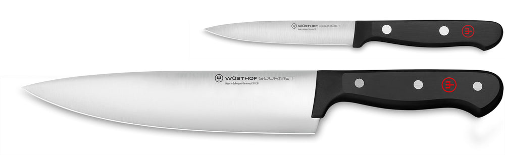 Side view of Wüsthof 8-inch chef and 4-inch utility knives with stainless blades and black riveted handles on white background