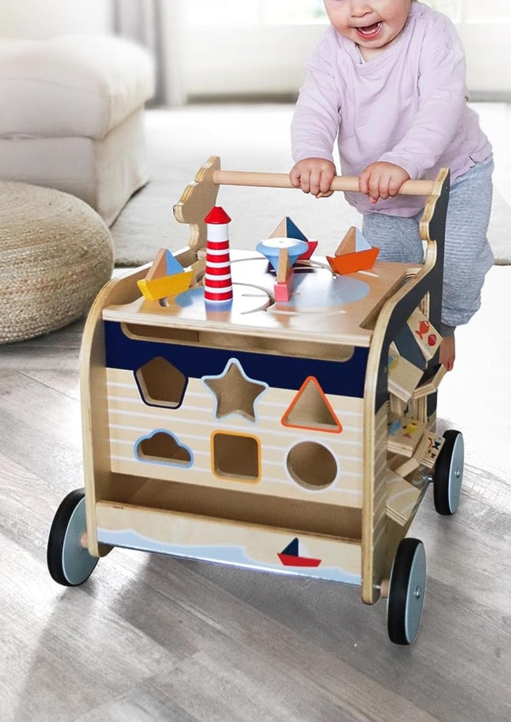 Front view of Navy Whale Theme 5-in-1 Baby Walker showcasing colorful activity pieces and shape sorter with child indoors