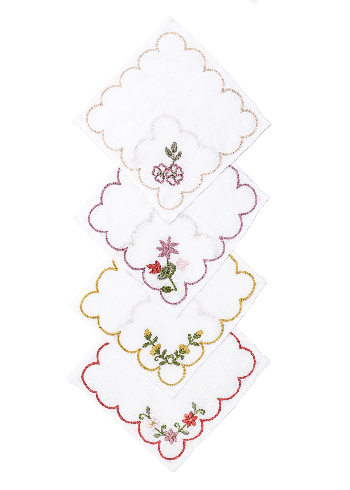 Angled view of OTM Exclusive cocktail napkins, set of 4 showcasing hand embroidered floral designs with a white background
