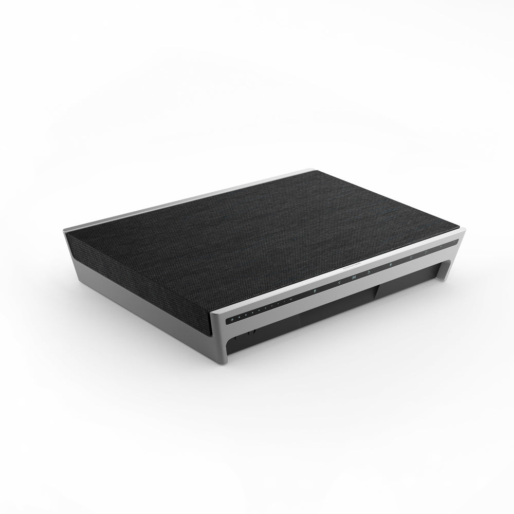 Angled view of Beosound Level Portable WiFi Speaker showcasing flat placement and front controls on a white background
