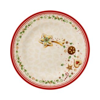 Top view of Winter Bakery Delight salad plate with Falling Star motif, red rim, and holly border on cream background