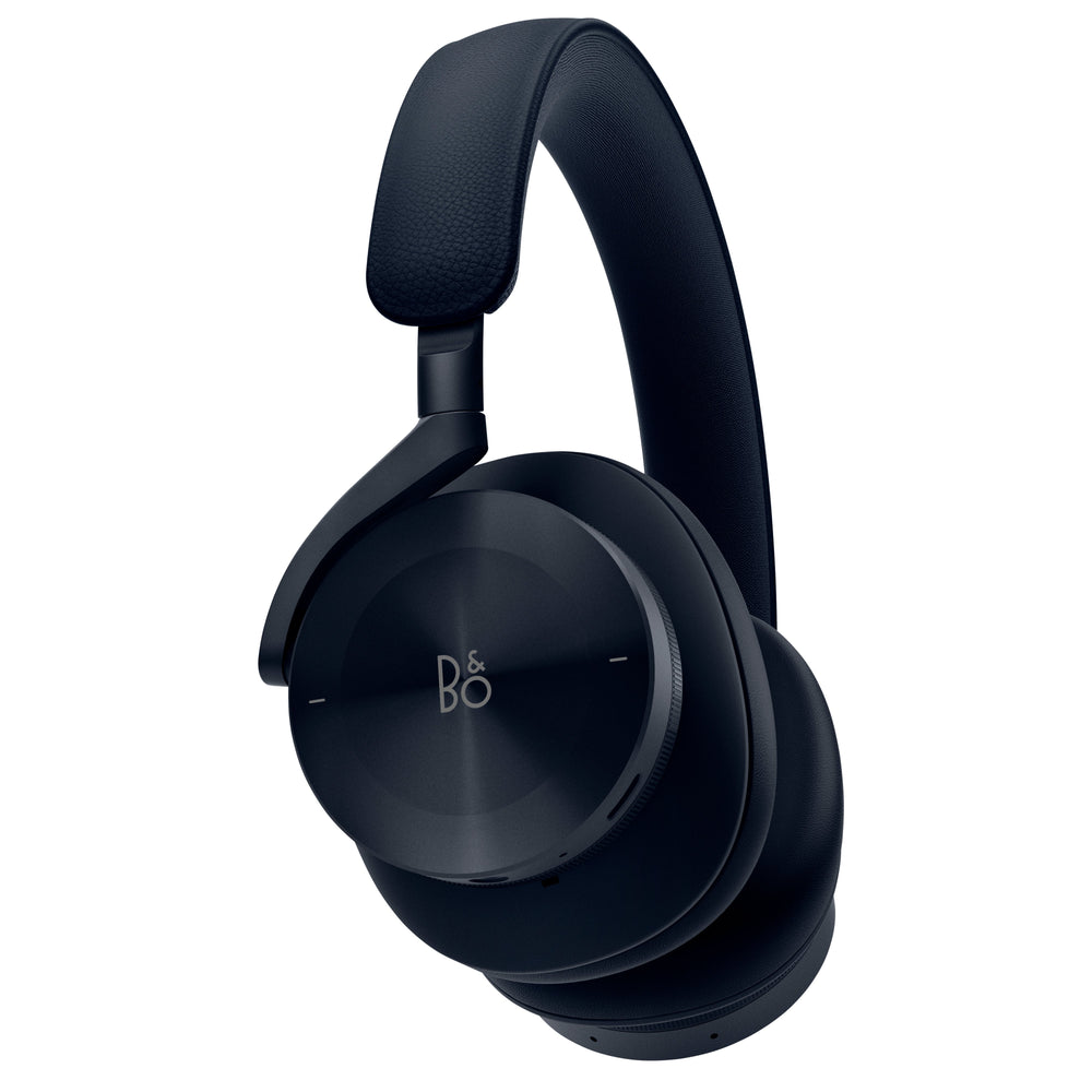 Angled view of B&O over-ear headphones showing right earcup with integrated control dial and padded headband on white background