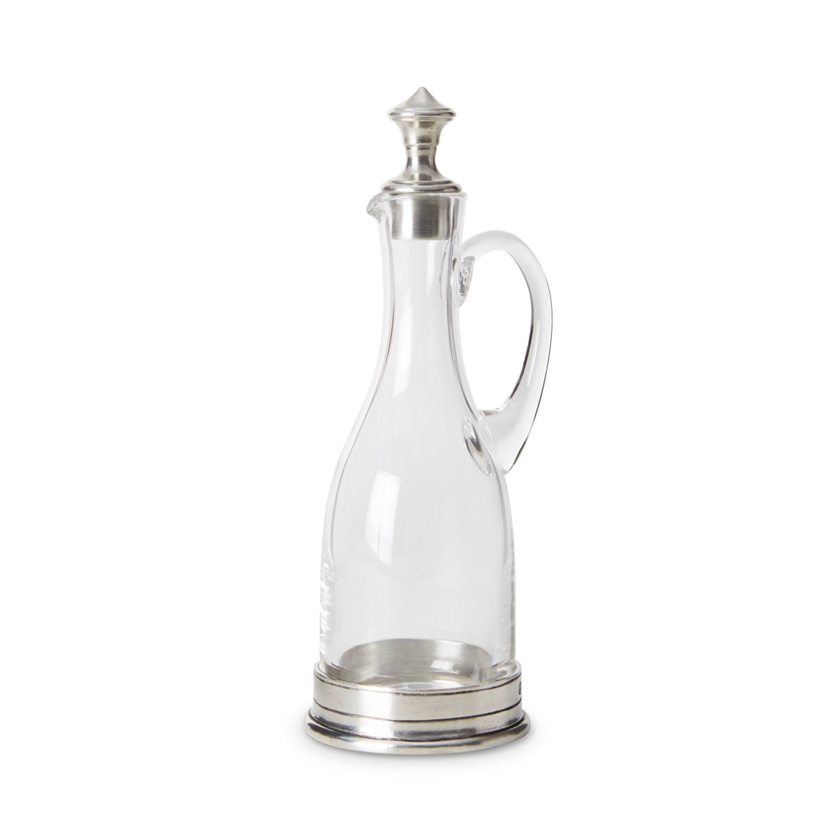 Front view of clear glass cruet with pewter stopper and pewter base showcasing side loop handle on white background
