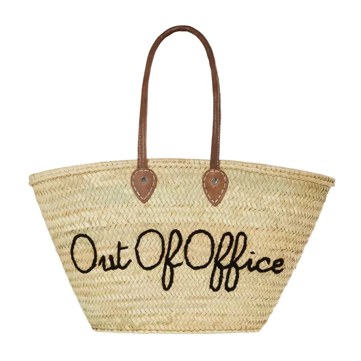 Front of large straw beach tote showcasing embroidered Out Of Office text and long brown leather handles on white background