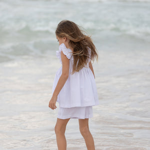 Henry Duvall girls smocked shorts set in Classic White, a classic two-piece outfit with flutter sleeves and blue embroidered smocking.