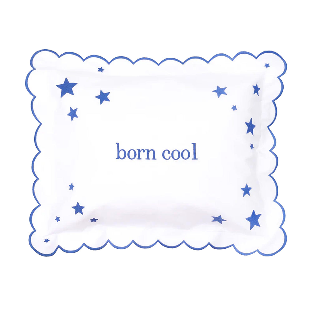 Front view of Born Cool Stars mini pillow with blue scalloped edge, star motifs, and central born cool text on white