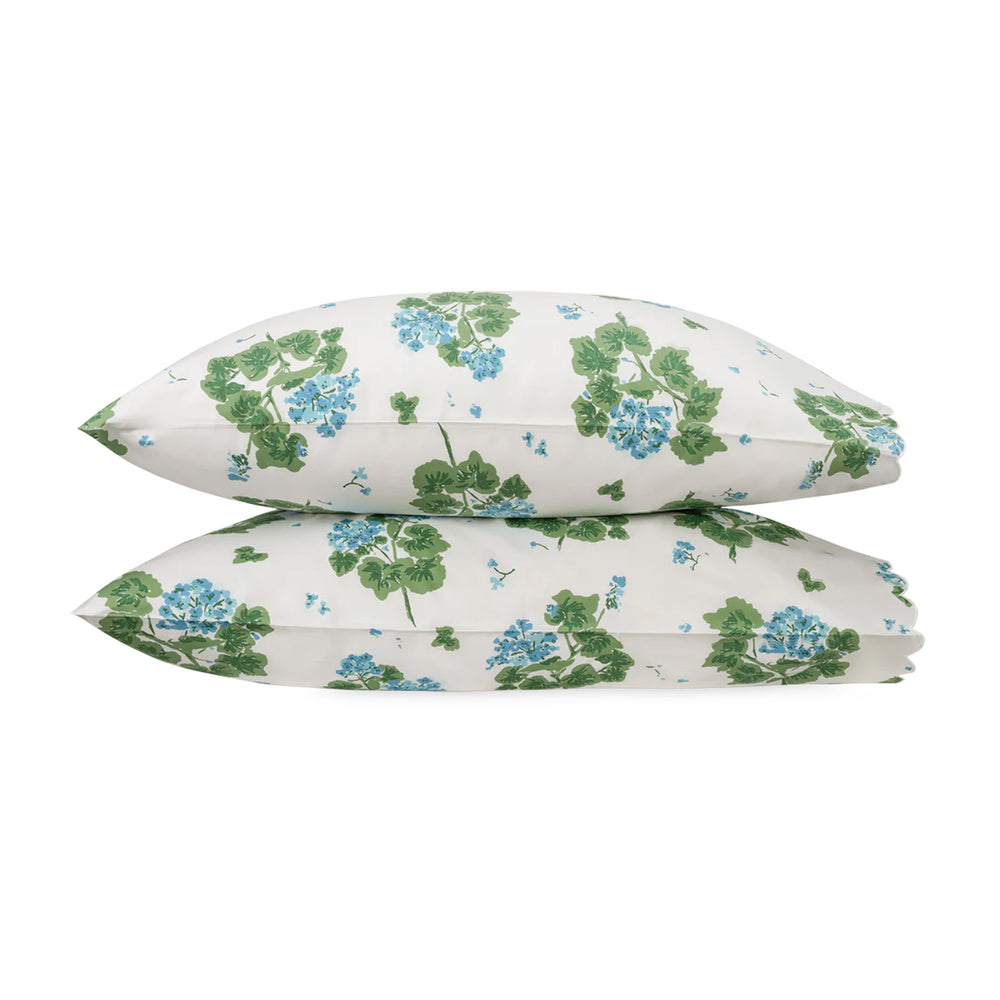 Stacked front view of Geranium pillowcases showcasing blue and green hand-drawn floral print on white background