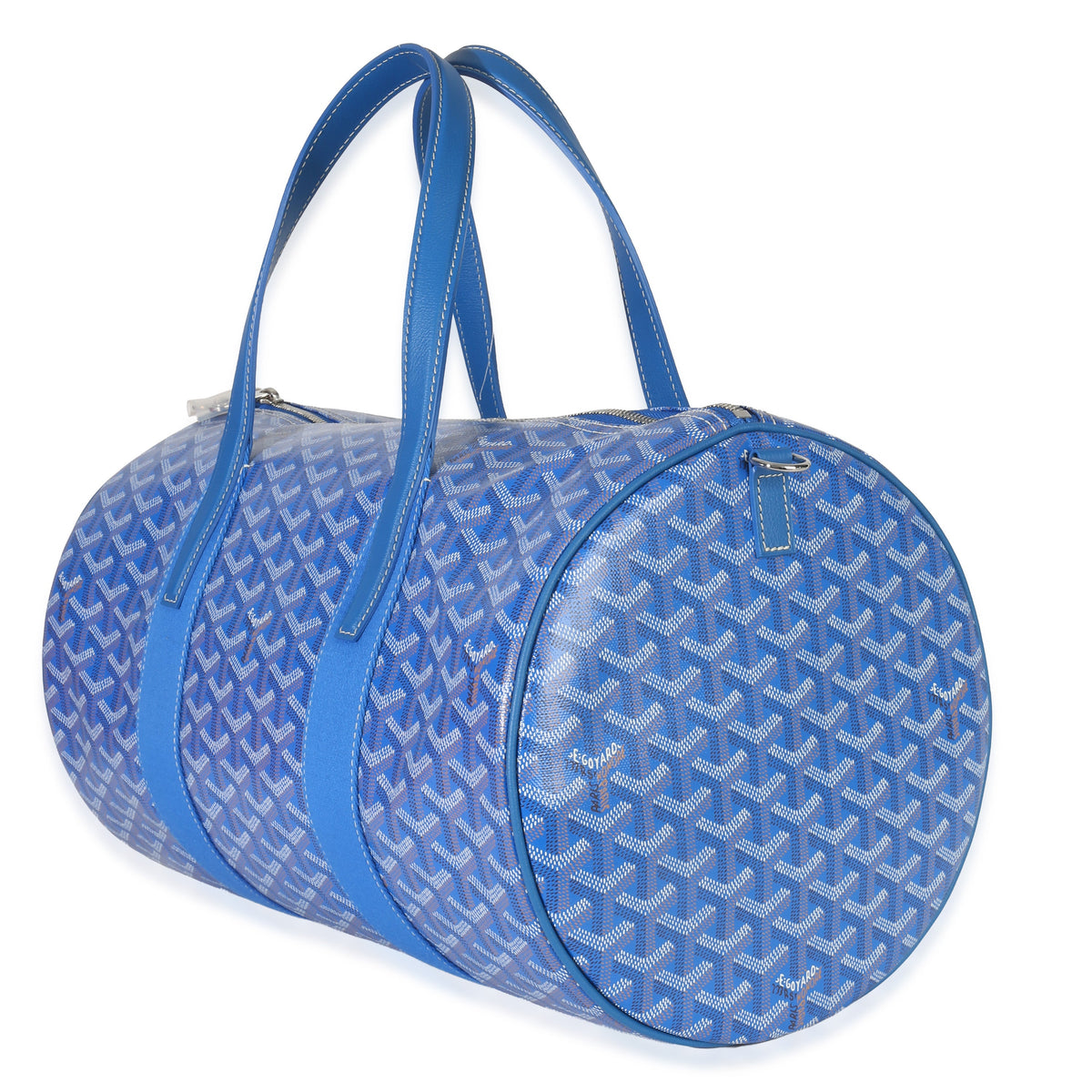 Three-quarter view of Goyardine Barrel 40 bag in sky blue, coated-canvas print, double handles, zip closure on white