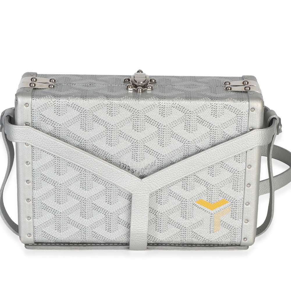 Front view of silver Goyardine Minaudière trunk bag with box shape, silver-tone hardware and shoulder strap on white background