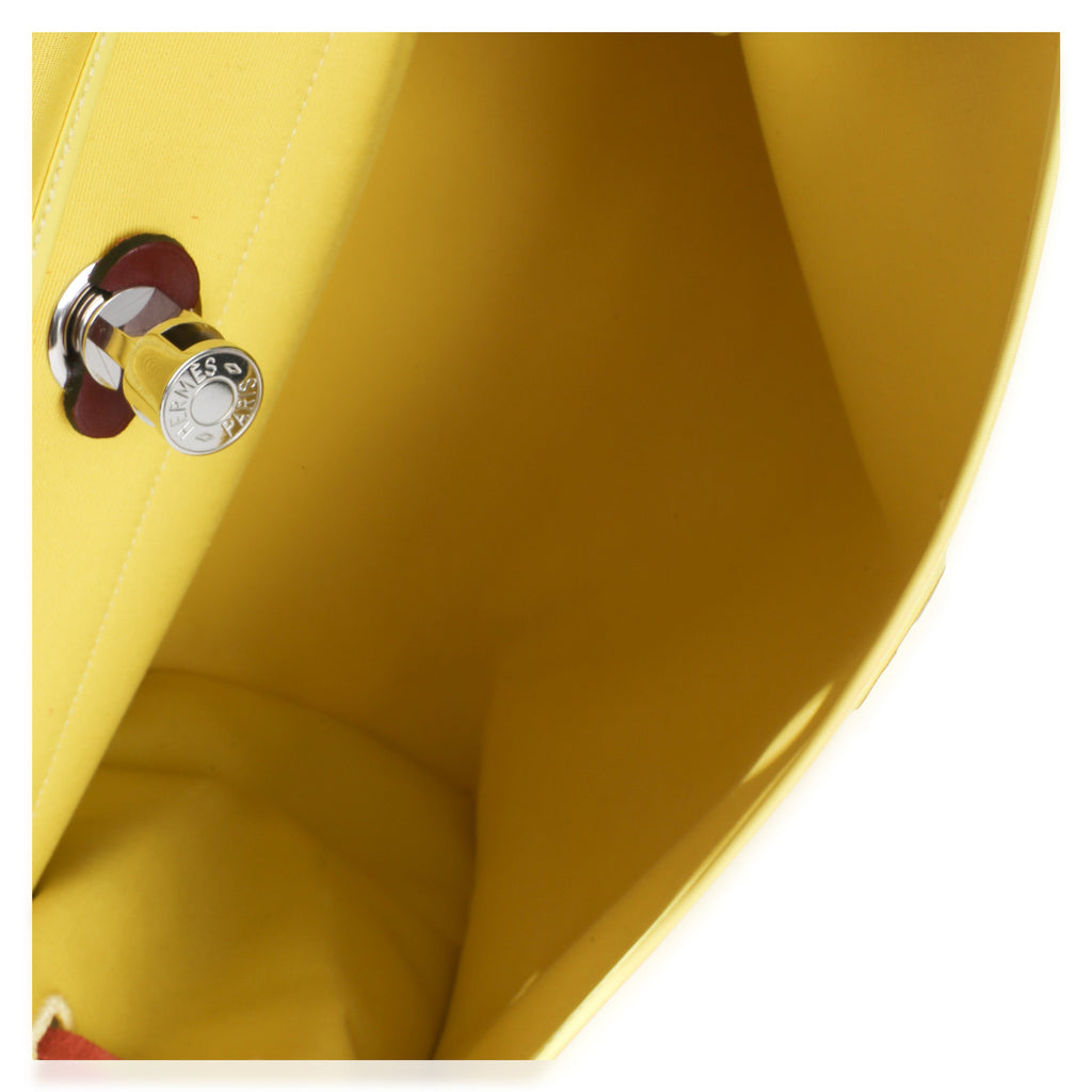 Close-up of Hermès Herbag 39 MM handbag showcasing yellow canvas interior and silver-tone hardware