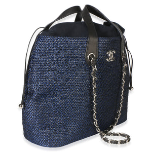 Front three-quarter view of Chanel Navy Blue Raffia CC Expandable Shopping Tote showcasing raffia, silver-tone hardware, and drawstring closure