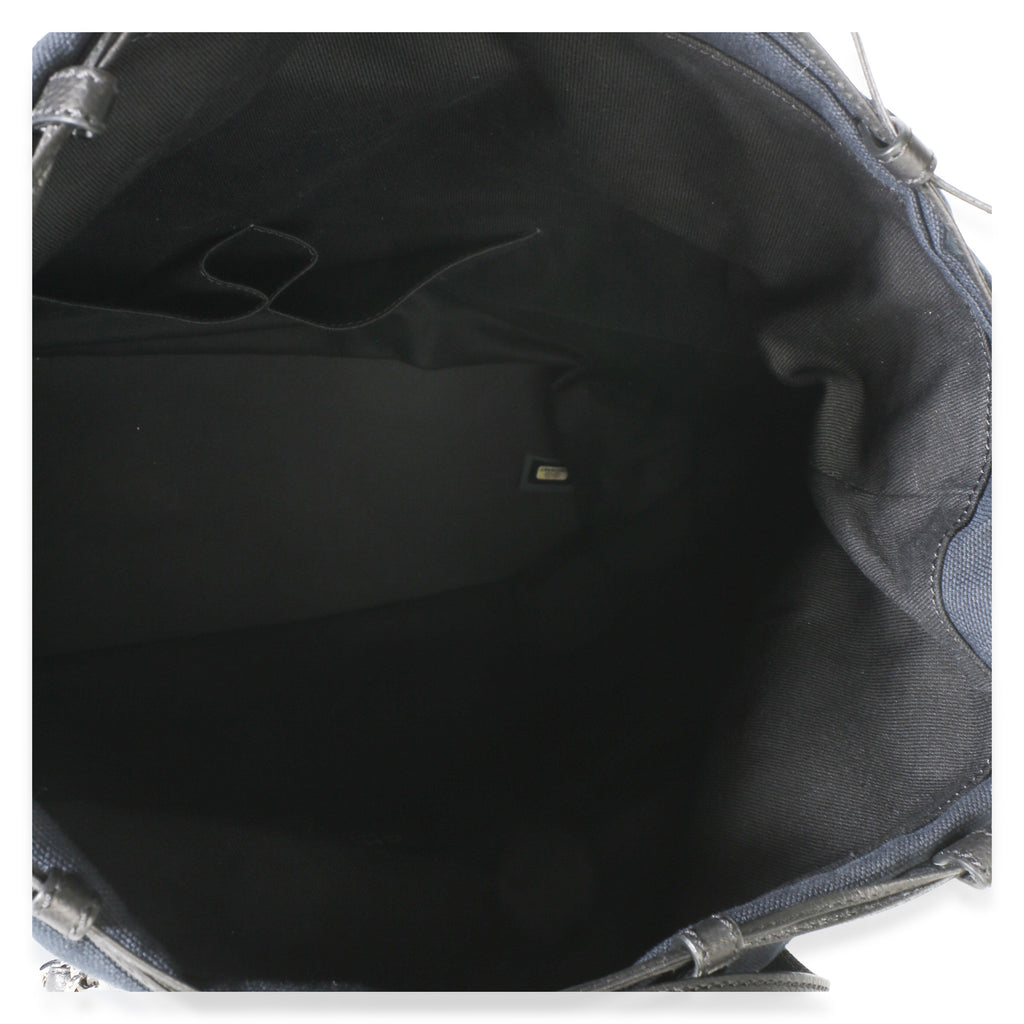 Top view of Chanel Navy Blue Raffia CC Expandable Shopping Tote showcasing its black fabric interior on a white background