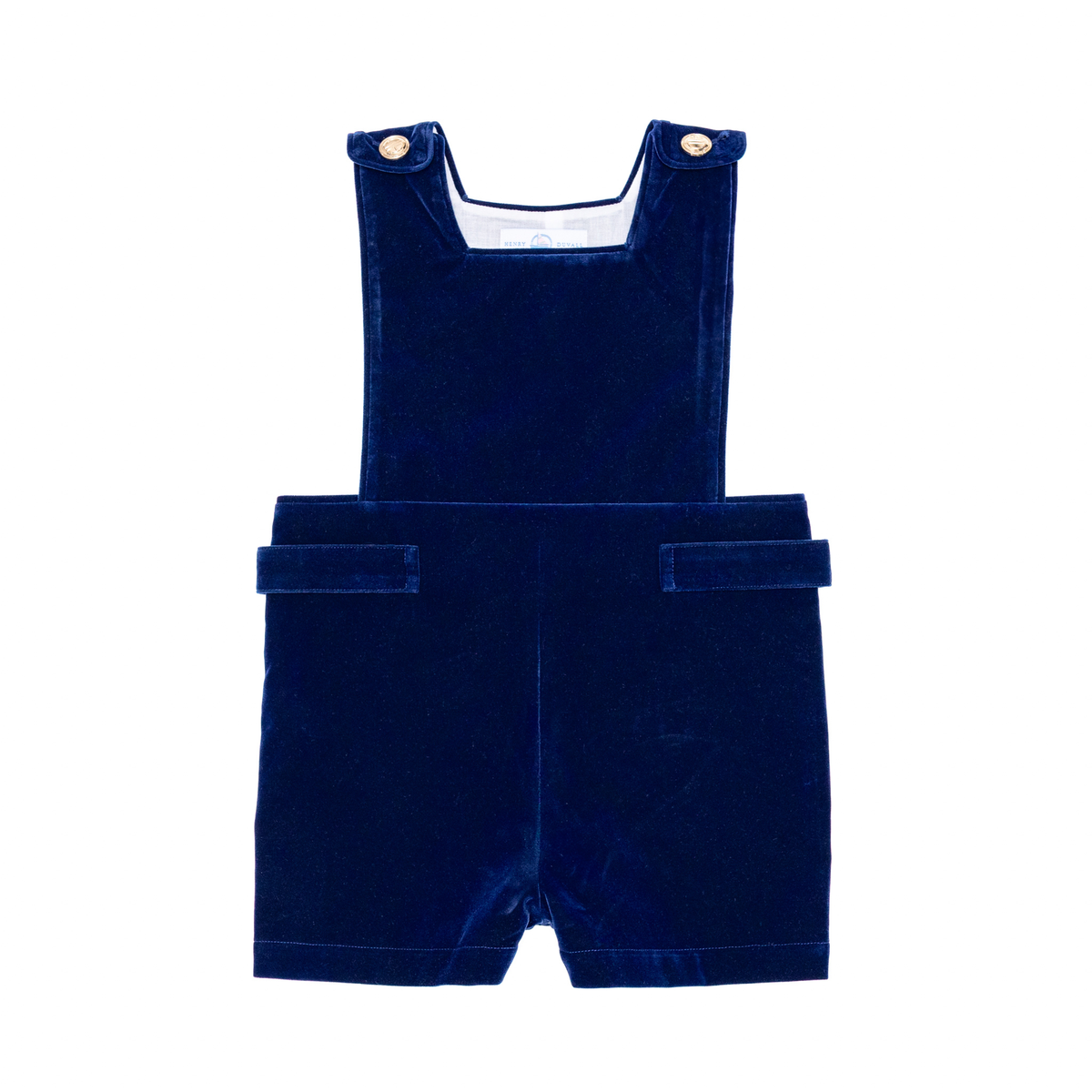 Front flat lay of James Henry Jon Jon in Back Bay blue velvet showcasing gold shoulder buttons and shortall on white background