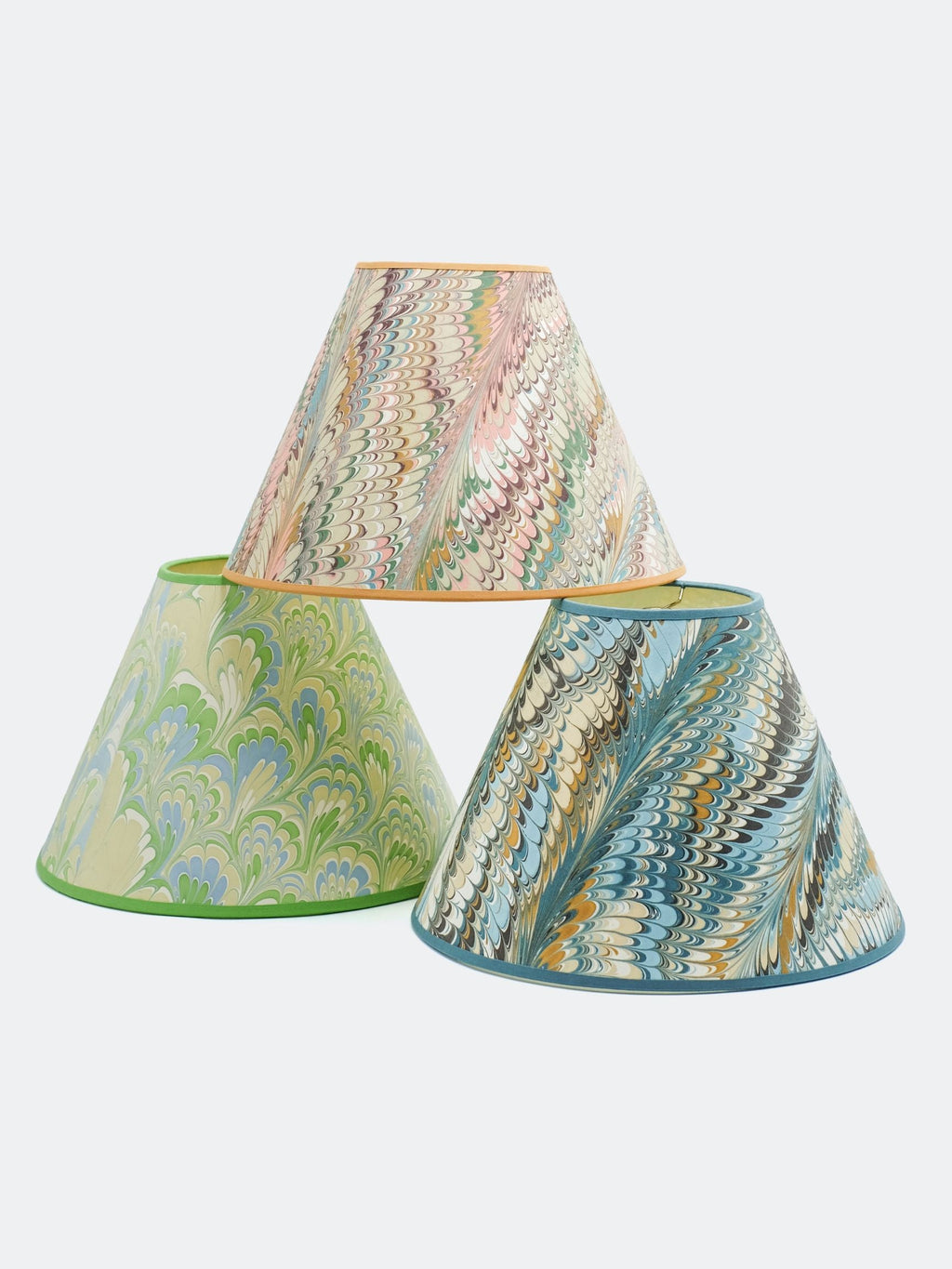 Three 16" hand-marbled empire lampshades with feather-inspired patterns in green, blue, and neutral tones, stacked display