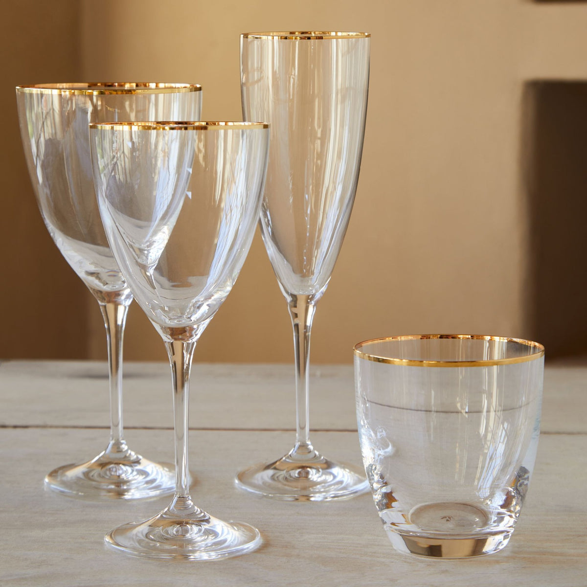 Close-up of Sensa Collection Flutes 8 oz in Golden Rim, Set of 6 showcasing clear glass and gold rims with a tabletop background