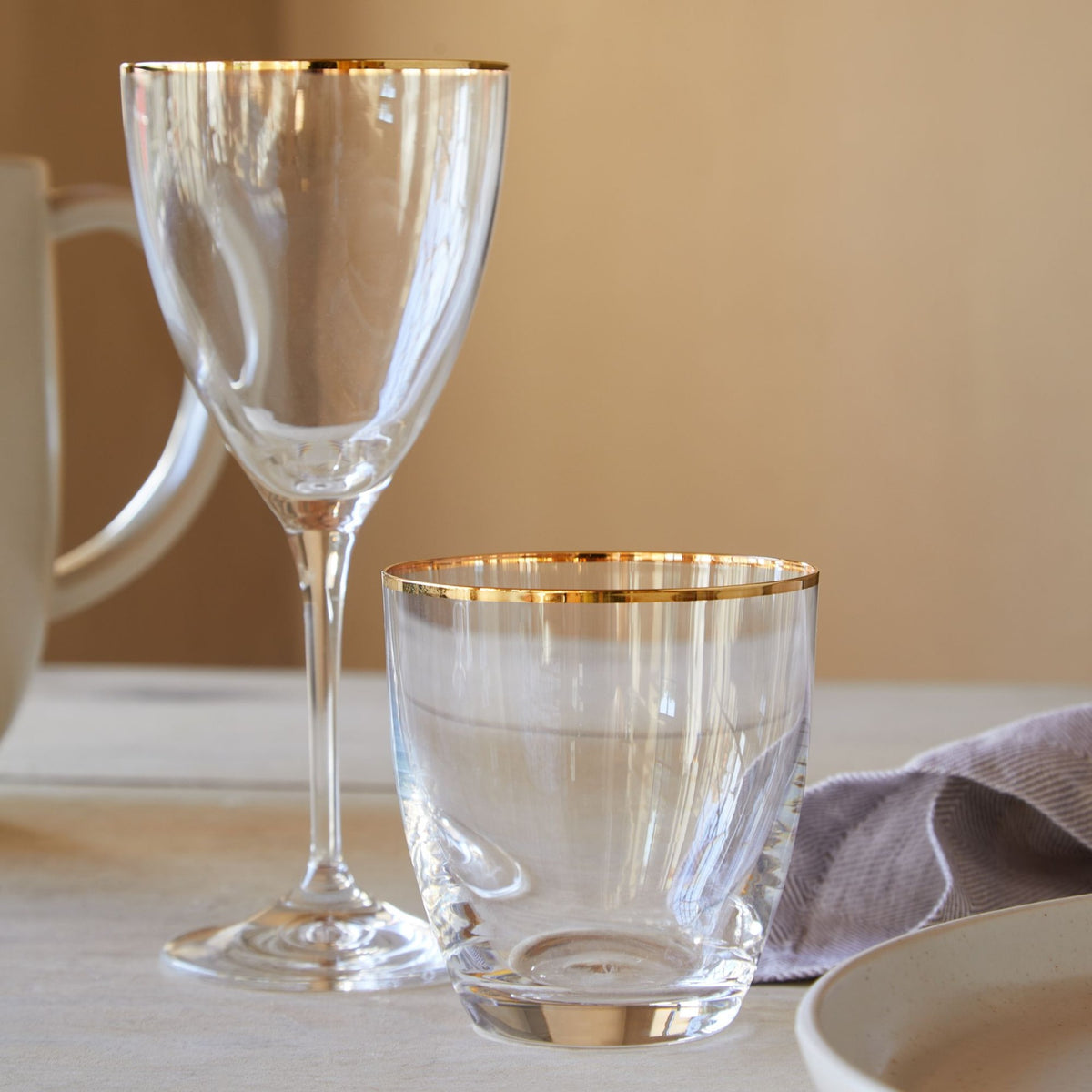 Close-up of Sensa Collection 10 oz tumblers showcasing golden rims on a tabletop