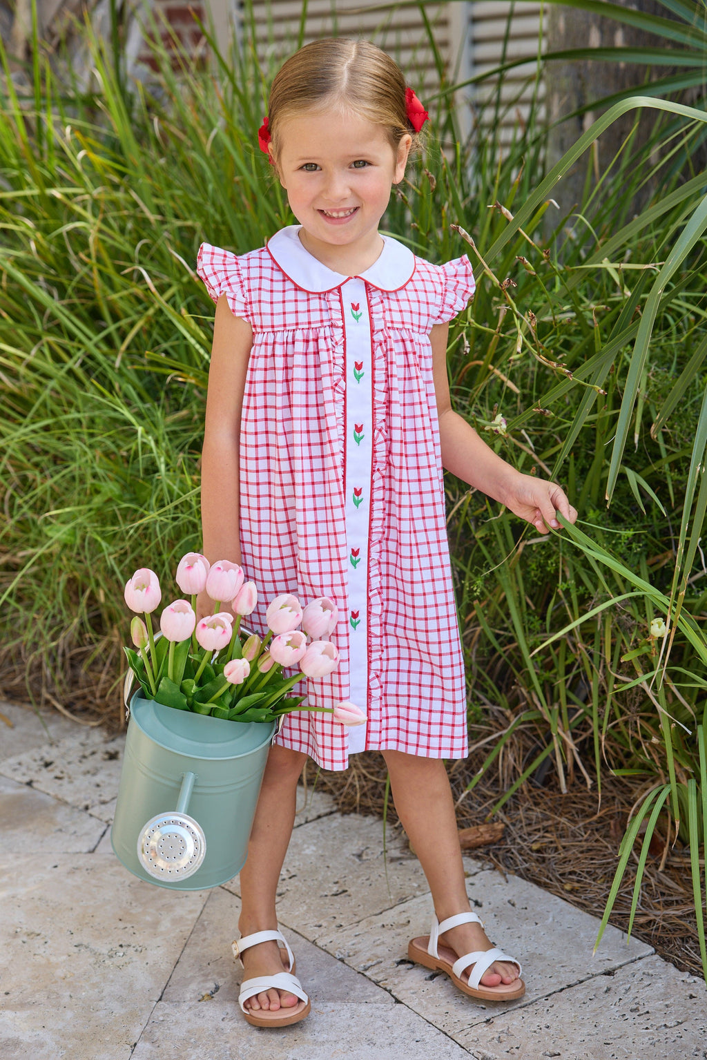 Little English traditional children's clothing. Classic dress for toddler girls in red windowpane with peter pan collar and tulip embroidery