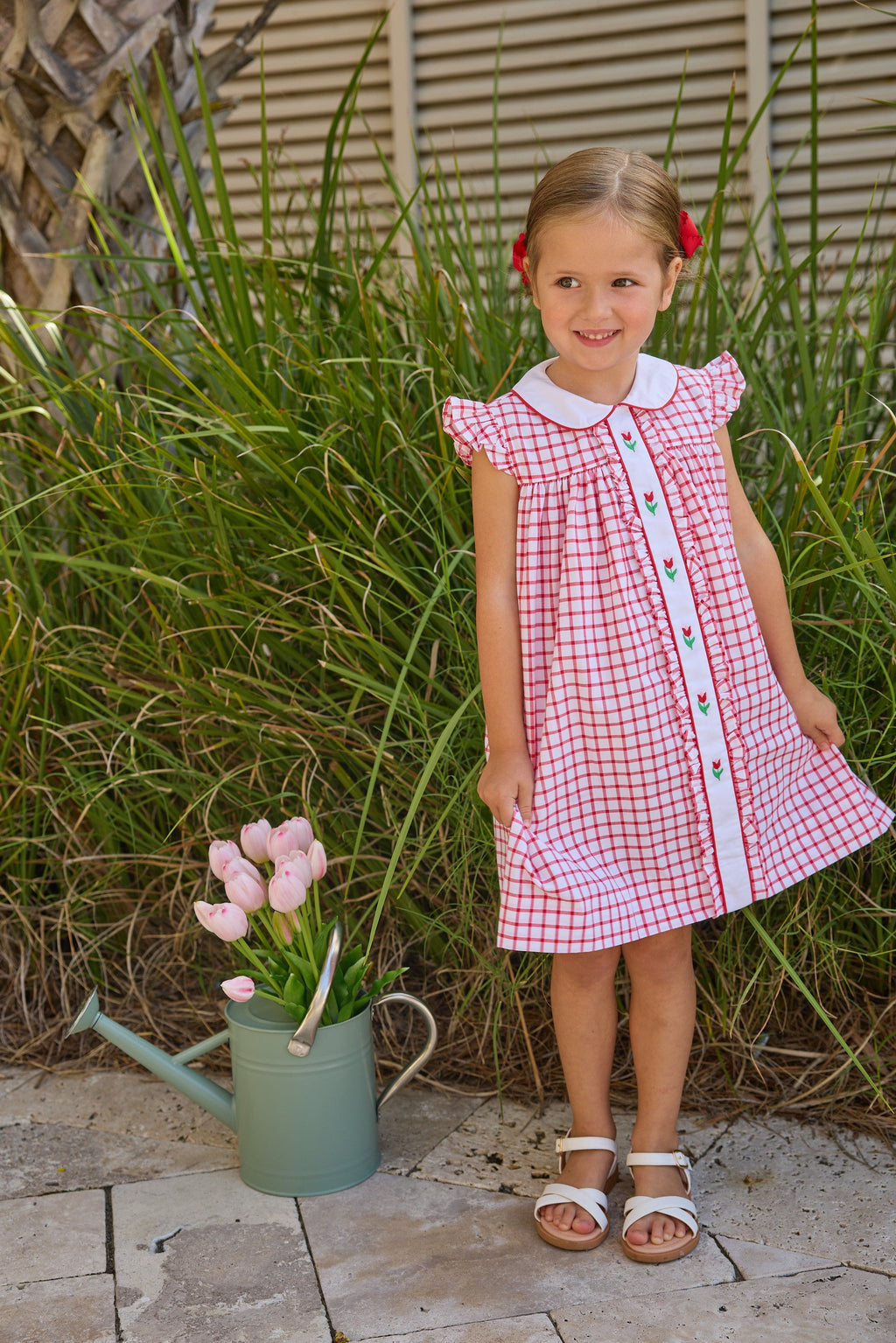 Little English traditional children's clothing. Classic dress for toddler girls in red windowpane with peter pan collar and tulip embroidery