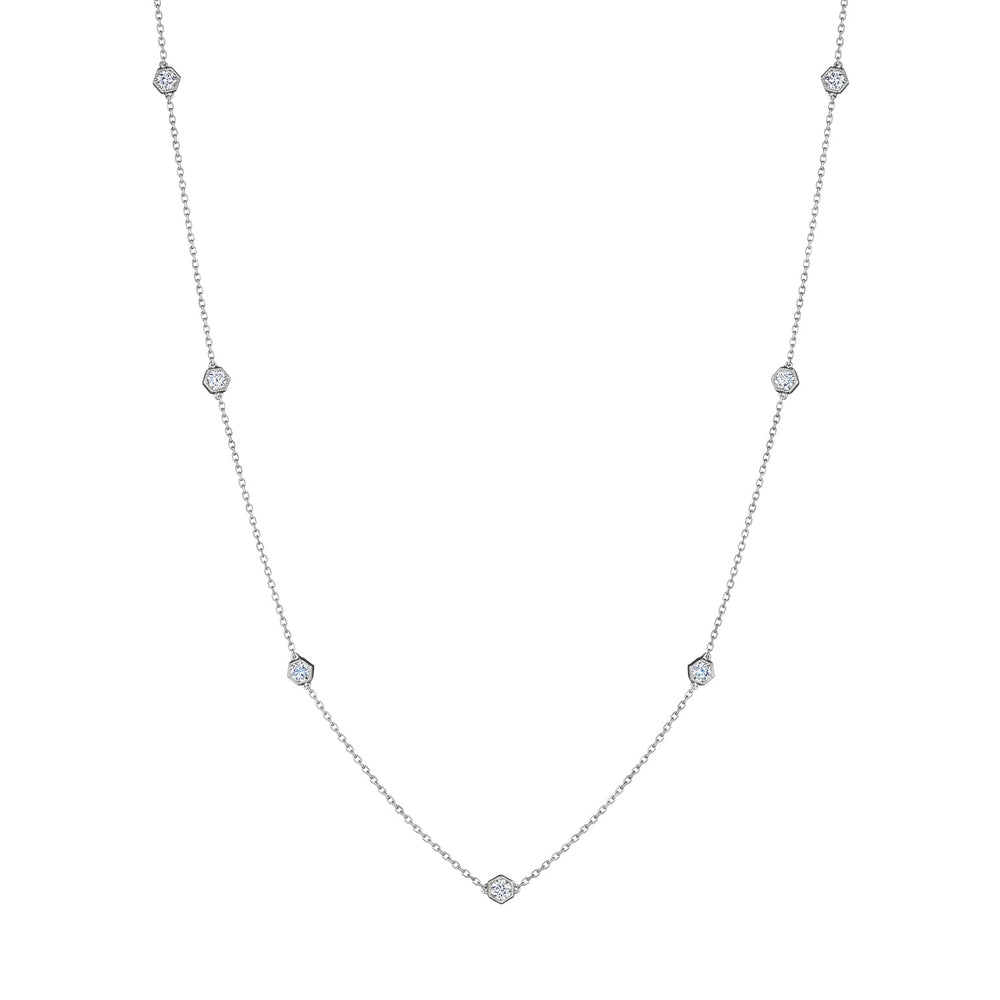 Small Serpentine Station Necklace in white gold, featuring hexagon bezel-set diamonds spaced along a fine chain, displayed on a white background.