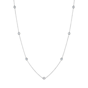 Small Serpentine Station Necklace in white gold, featuring hexagon bezel-set diamonds spaced along a fine chain, displayed on a white background.
