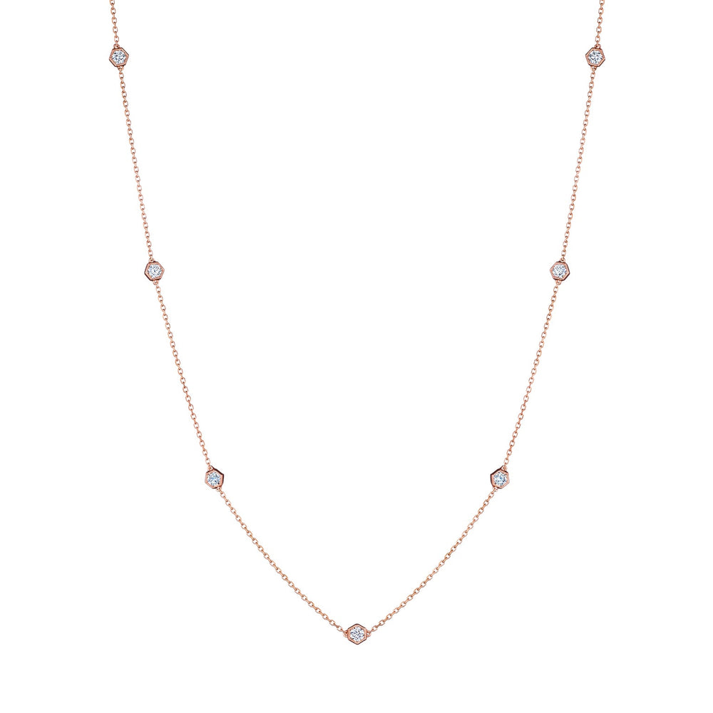 The Small Serpentine Station Necklace features hexagon bezel set diamonds spaced along a fine chain, shown on a plain white background.