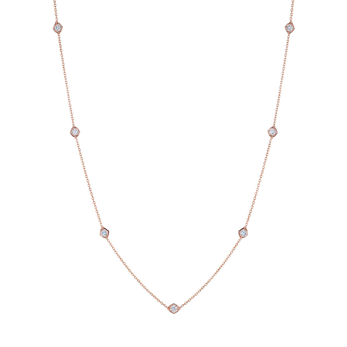 The Small Serpentine Station Necklace features hexagon bezel set diamonds spaced along a fine chain, shown on a plain white background.