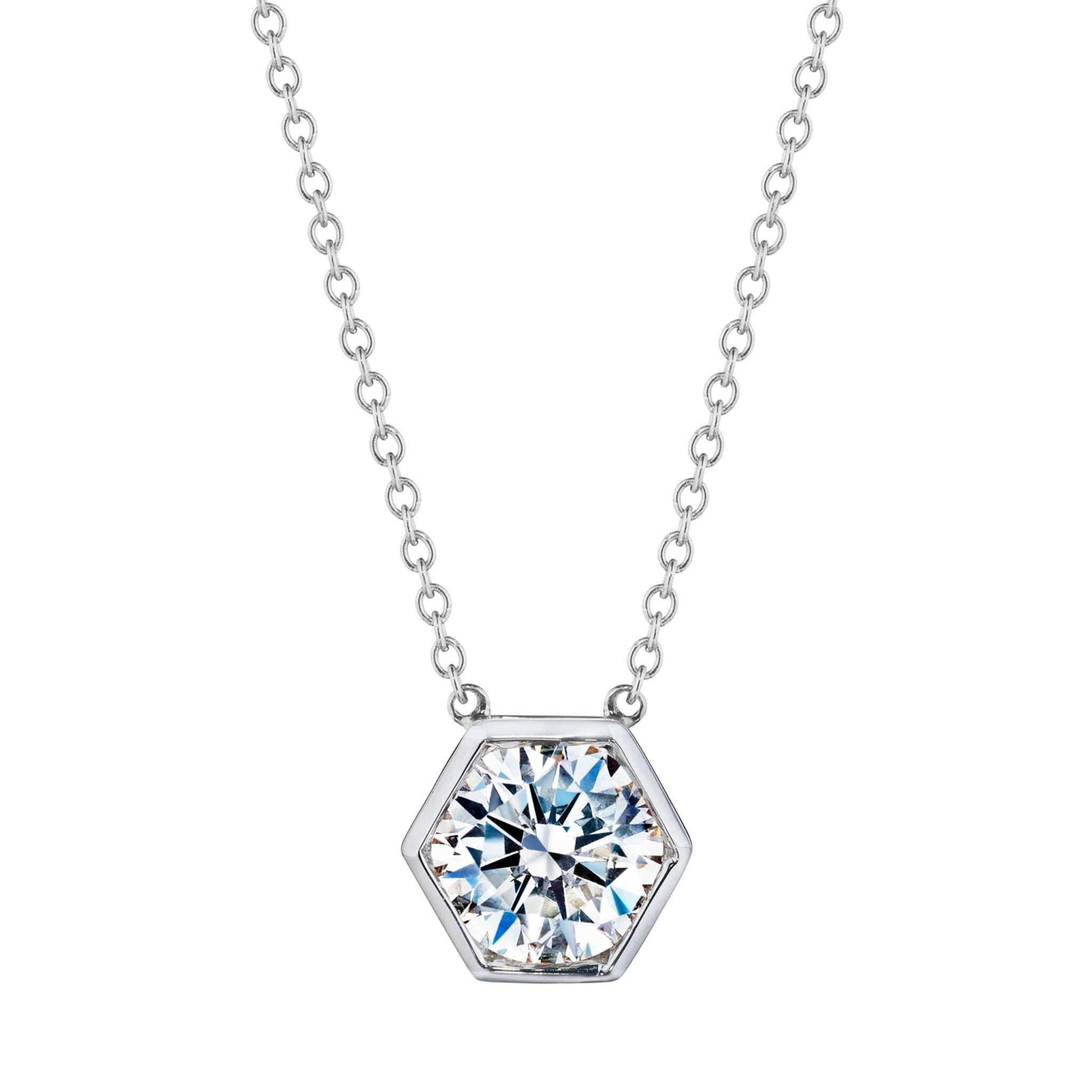 The Hexagon Bezel Set Round Brilliant Diamond Pendant showcases a sparkling round solitaire diamond at the center of a silver chain necklace.