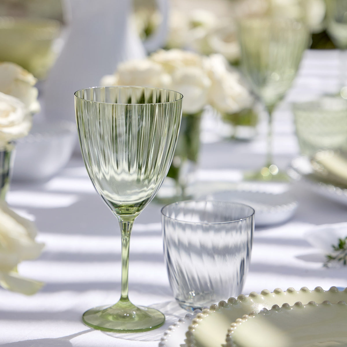 Close-up of a Smokey Grey Sensa Collection tumbler showcasing its cut-rim finish on a softly lit table