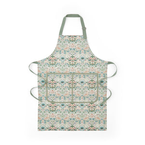 Front view of Morris & Co. apron showcasing its botanical pattern and divided front pocket with green ties on a white background