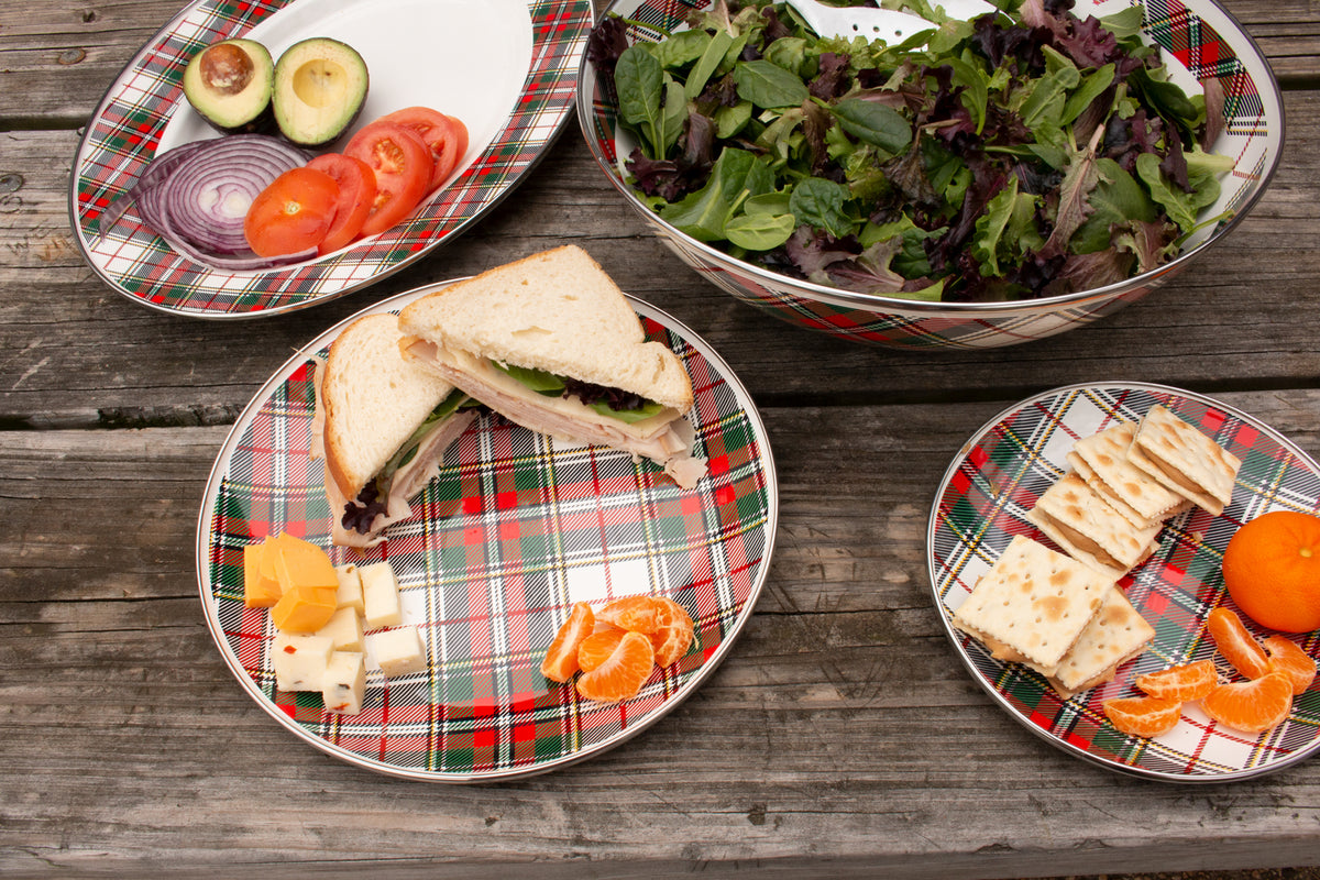 Sandwich plates in Highland Plaid arranged with sandwiches, salad, cheese, crackers, and fruit on a wooden table